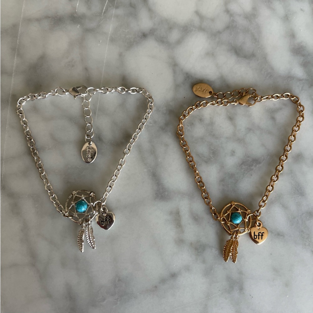 Matching BFF charm bracelets in gold and silver.